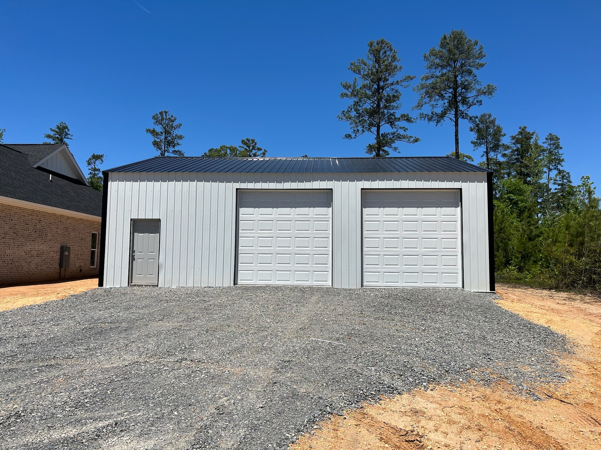 Quality Barns & More metal garage with two overhead doors